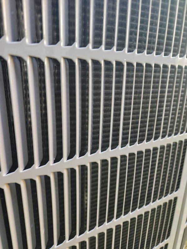 Completed scheduled cooling system maintenance tune-up on properly functioning HVAC unit for service plan member. Performed comprehensive inspection of condenser coil fins, evaporator coil assembly, refrigerant lines, and drain pan, documenting system condition with photographs showing clean, well-maintained components with no visible deficiencies. System confirmed operational with all components functioning within normal parameters.