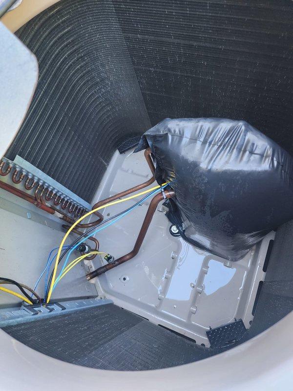 Completed scheduled cooling system maintenance tune-up on properly functioning HVAC unit for service plan member. Performed comprehensive inspection of condenser coil fins, evaporator coil assembly, refrigerant lines, and drain pan, documenting system condition with photographs showing clean, well-maintained components with no visible deficiencies. System confirmed operational with all components functioning within normal parameters.