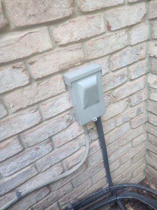 Completed warranty recall work on outdoor A/C unit installation. Added UL-listed strapping to secure flexible conduit between outdoor disconnect and condensing unit, properly fastening conduit to dwelling exterior per code requirements. Upgraded circuit breaker from existing 20-amp to required 25-amp breaker to meet manufacturer specifications with 30-amp maximum rating. Applied proper identification labeling to outdoor unit indicating "Upstairs A/C" to match corresponding furnace labeling for system identification. Documented completed work with photographic evidence of properly secured conduit runs along brick exterior and corrected electrical disconnect installation.
