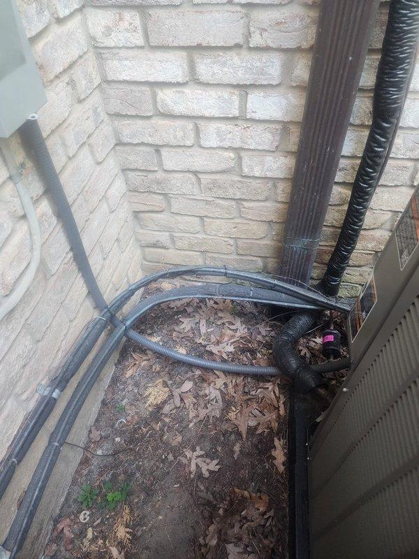 Completed warranty recall work on outdoor A/C unit installation. Added UL-listed strapping to secure flexible conduit between outdoor disconnect and condensing unit, properly fastening conduit to dwelling exterior per code requirements. Upgraded circuit breaker from existing 20-amp to required 25-amp breaker to meet manufacturer specifications with 30-amp maximum rating. Applied proper identification labeling to outdoor unit indicating "Upstairs A/C" to match corresponding furnace labeling for system identification. Documented completed work with photographic evidence of properly secured conduit runs along brick exterior and corrected electrical disconnect installation.