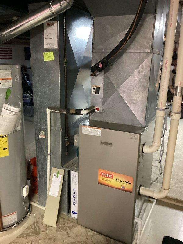 Conducted comprehensive HVAC replacement estimate for dual-system residential installation, evaluating two 20-year-old units including Bryant Plus 90i furnace and associated air handler equipment located in basement mechanical room. Documented existing equipment configuration, ductwork connections, venting systems, and utility connections through detailed photographic assessment to provide accurate replacement specifications for complete system upgrade.