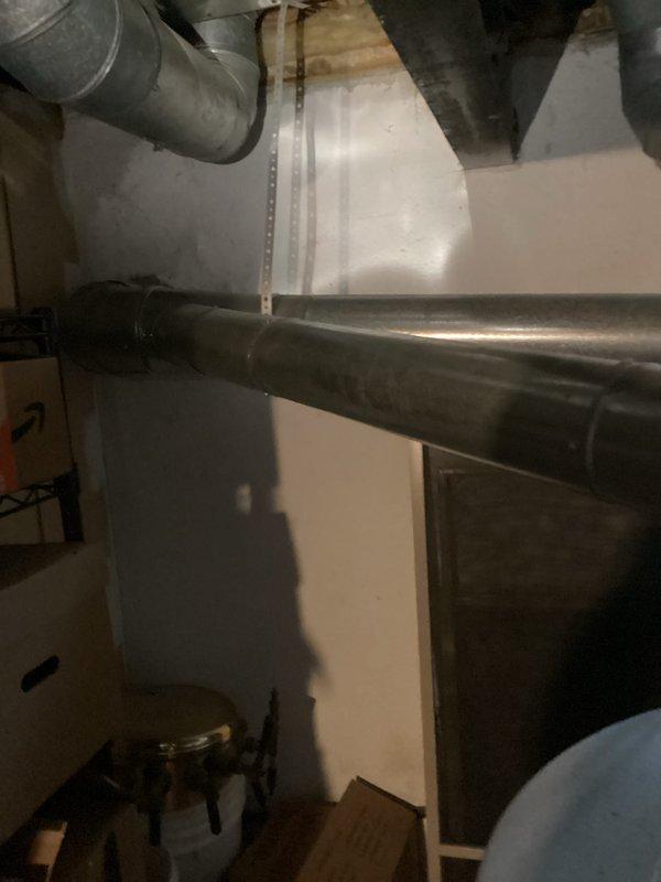 Conducted estimate for full HVAC system replacement and standalone A/C replacement options. Upon inspection, found existing system operating with low R22 refrigerant charge, indicating potential leak in refrigerant circuit. Documented current equipment configuration including aging ductwork system, water heater, and associated mechanical components showing signs of corrosion and wear. Photographed existing infrastructure to support replacement recommendations, capturing deteriorated piping with visible oxidation, aged metal ductwork with surface discoloration, and overall system layout in basement utility area. Provided customer with comprehensive replacement options addressing refrigerant deficiency and aging equipment concerns.