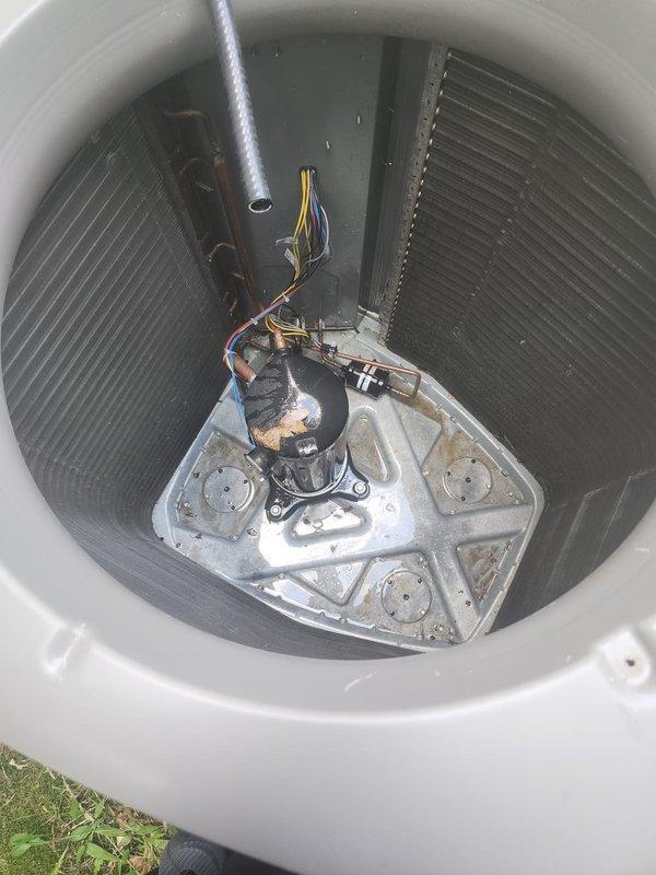 Replaced defective condenser fan motor on residential outdoor heat pump unit. Removed top grille assembly, disconnected failed motor from electrical connections and mounting bracket, and installed new replacement motor with proper wiring connections. Verified unit operation with successful startup, confirmed proper fan rotation and airflow through condenser coil, and secured all components before returning system to normal service.