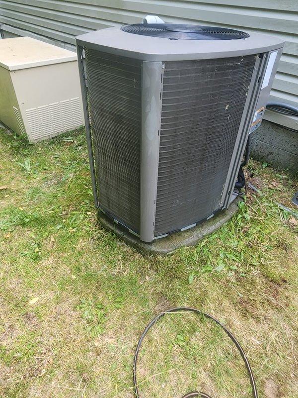 Replaced defective condenser fan motor on residential outdoor heat pump unit. Removed top grille assembly, disconnected failed motor from electrical connections and mounting bracket, and installed new replacement motor with proper wiring connections. Verified unit operation with successful startup, confirmed proper fan rotation and airflow through condenser coil, and secured all components before returning system to normal service.