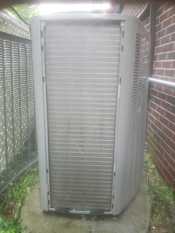 Completed scheduled cooling season maintenance on residential HVAC system. Performed comprehensive tune-up inspection of outdoor condenser unit, which was found to be operational. Unit exterior showed typical environmental accumulation on coil fins and surfaces. Documented equipment condition with photographs showing condenser installation on concrete pad in side yard location between brick wall and lattice screening. System confirmed working properly at time of service visit.