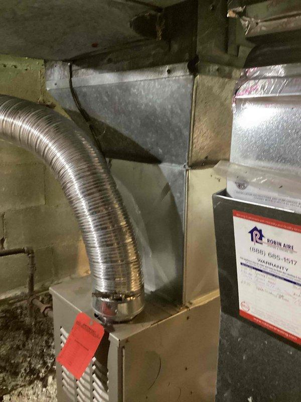 Completed comprehensive estimate for full air conditioning system replacement at residential property. Assessed existing Robin Aire furnace installation in basement utility area with current ductwork configuration including metallic flex duct connections and galvanized metal supply runs. Evaluated outdoor condensing unit positioned against exterior wall with existing electrical disconnect and conduit routing. Documented equipment specifications, spatial constraints, and electrical infrastructure to provide customer with replacement options for complete HVAC system upgrade.