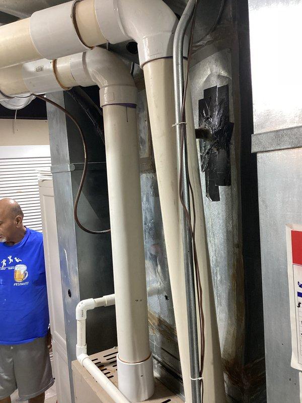 Provided comprehensive estimate for complete HVAC system replacement in a two-story colonial home with basement installation. The existing 20-year-old air conditioning system has failed and requires replacement, while the furnace remains operational. Assessment included evaluation of the current basement-mounted equipment configuration, existing ductwork infrastructure, condensate drainage system with PVC piping, and electrical connections to determine optimal replacement specifications for both heating and cooling components.