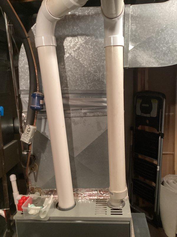 Conducted on-site assessment of existing 13-year-old furnace system to provide replacement estimate. Inspected current furnace installation in basement, including PVC venting system with U-shaped configuration, condensate pump assembly with drainage components, and associated ductwork. Evaluated existing air handler unit, copper refrigerant lines, and filter system. Documented equipment specifications, installation layout, and mechanical room configuration. Reviewed outdoor AC unit location at rear of property. Provided homeowner with comprehensive replacement options and equipment recommendations for new furnace installation, noting current system remains operational with no immediate failures or performance issues reported.