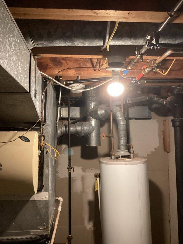 Conducted comprehensive HVAC system evaluation for air conditioning replacement estimate on 900 square foot residential property experiencing inadequate cooling performance and insufficient airflow. Assessed existing older AC unit that was unable to maintain comfortable temperatures, with indoor conditions consistently reaching 80+ degrees despite continuous operation. Evaluated current system capacity, ductwork condition, and air distribution throughout the home. Inspected basement mechanical space including existing HVAC equipment, ductwork configuration, and related utility infrastructure. Documented existing copper piping, insulated ductwork runs, and overall system layout to determine proper replacement sizing and identify necessary ductwork modifications to address airflow deficiencies and improve cooling efficiency.