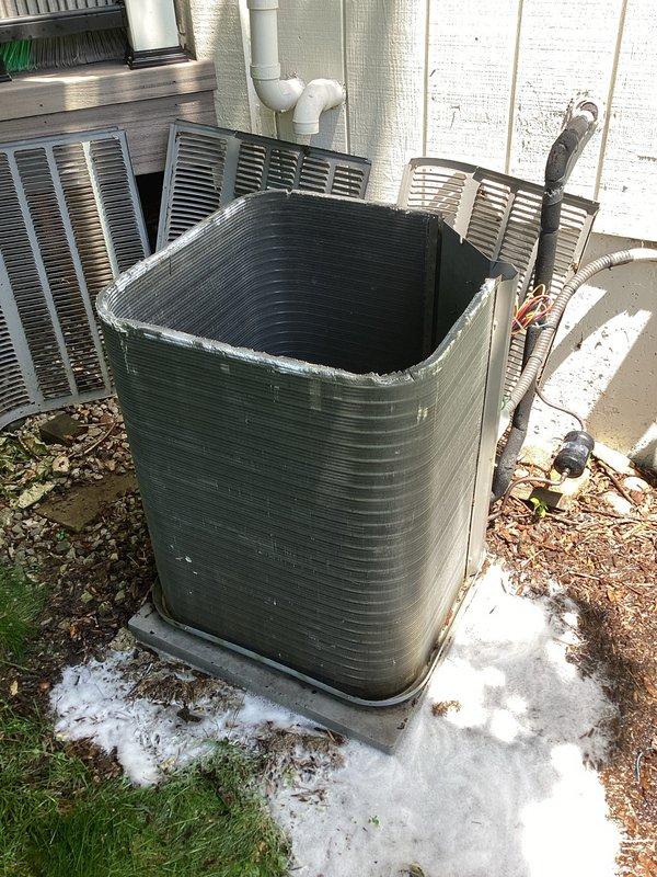 Responded to no cooling complaint on aging residential air conditioning system. Upon inspection, found unit blowing warm air with compressor not operating. Diagnosed failed compressor motor with visible corrosion on base pan and electrical connections. Unit showed significant age-related wear including deteriorated drain pan and accumulated debris. Advised customer of compressor failure and provided replacement options for the 10+ year old system.