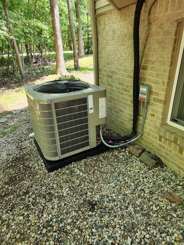 Completed installation of Bryant air conditioning system including outdoor condensing unit positioned on rubber isolation pad with proper clearances and indoor air handler connections. Installed Ecobee6 smart thermostat with full system integration and programmed for optimal cooling performance. Added whole-home humidifier to existing HVAC system with proper ductwork connections and water supply line installation. Ran refrigerant lines between indoor and outdoor units through exterior wall penetration, sealed and insulated all line sets per manufacturer specifications. Installed electrical disconnect box on exterior wall with weatherproof conduit protecting power supply wiring to condensing unit. Verified proper refrigerant charge, tested system operation through complete cooling cycle, and confirmed all electrical connections meet code requirements. System commissioned and operational.