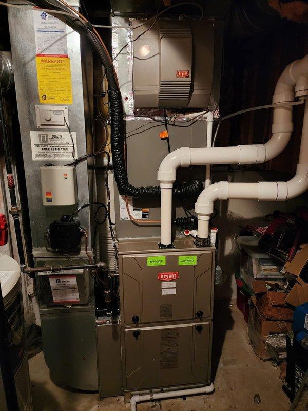 Completed installation of new Lennox air conditioning system including outdoor condenser unit positioned on gravel pad adjacent to existing Bryant furnace in basement mechanical room. Installed refrigerant lines, condensate drainage piping, electrical connections, and integrated new A/C coil with existing furnace system. All equipment tested and operational, with proper airflow verified and system commissioned per manufacturer specifications.