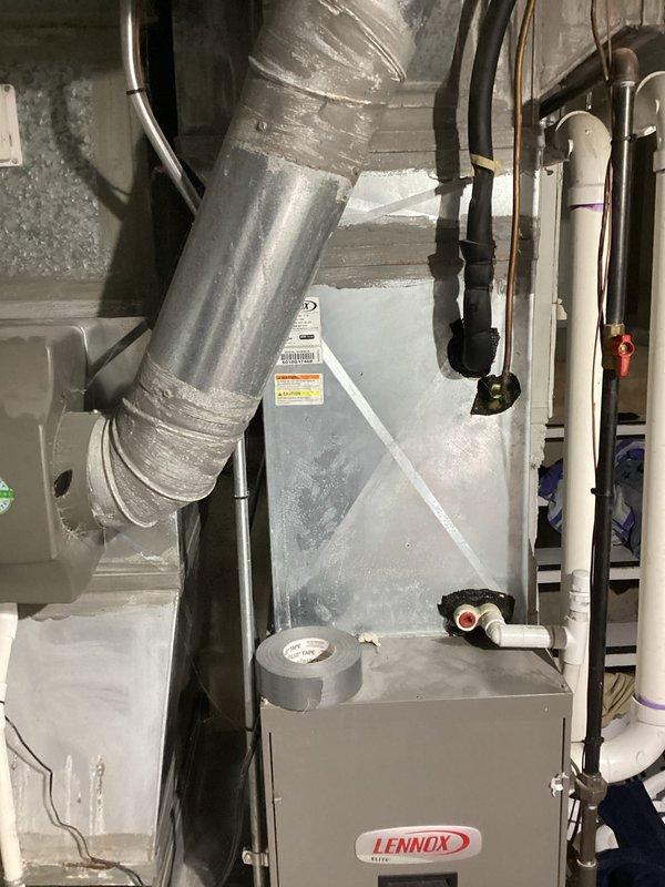Assessed non-functional 18-year-old residential air conditioning system and provided replacement estimate quotes (04211-01 and 04211-02). Evaluated existing Lennox furnace in basement mechanical room with connected ductwork and outdoor condensing unit positioned adjacent to deck, documenting current system configuration and condition to support equipment replacement recommendations.