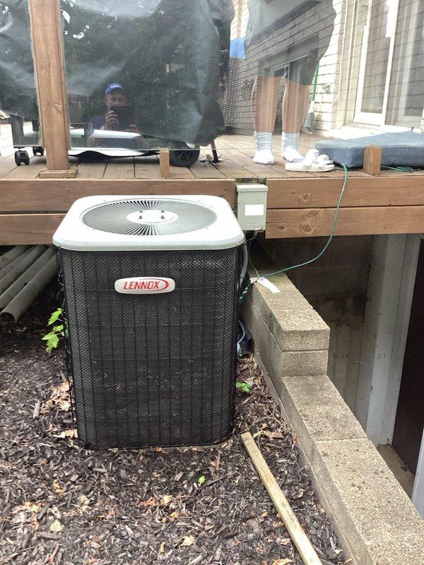 Assessed non-functional 18-year-old residential air conditioning system and provided replacement estimate quotes (04211-01 and 04211-02). Evaluated existing Lennox furnace in basement mechanical room with connected ductwork and outdoor condensing unit positioned adjacent to deck, documenting current system configuration and condition to support equipment replacement recommendations.