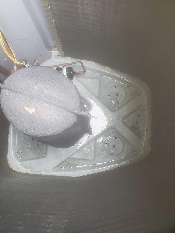 Completed preventive maintenance inspection on residential cooling system under Worry Free Service Agreement. Performed comprehensive evaluation of outdoor condenser unit and indoor air handler components, including inspection of condensate drain pan with active moisture accumulation indicating proper system operation. All equipment found operating within normal parameters with no deficiencies noted.