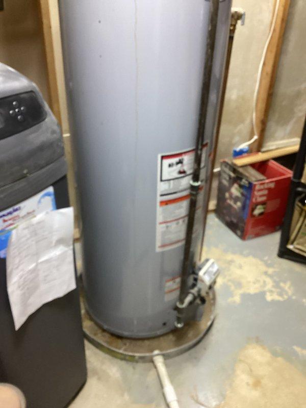 Completed on-site assessment of existing water heater installation in basement utility area. Inspected current unit, surrounding plumbing connections, gas lines, venting system, and clearance requirements. Documented existing configuration including water supply lines, gas piping with shutoff valve, temperature and pressure relief valve discharge piping, and exhaust ductwork connections. Photographed installation for replacement estimate preparation. Evaluated accessibility, structural support, and code compliance considerations for water heater replacement.
