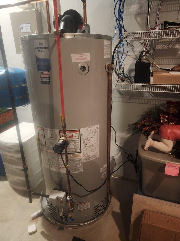 Corrected relief valve discharge piping on Bradford White water heater to comply with Section 28 of Michigan 2015 MRC requirements. Installed proper drainage system with appropriate PVC piping and fittings, documented installation with photographs per inspection protocol, and completed required follow-up documentation to satisfy warranty compliance without necessitating re-inspection.