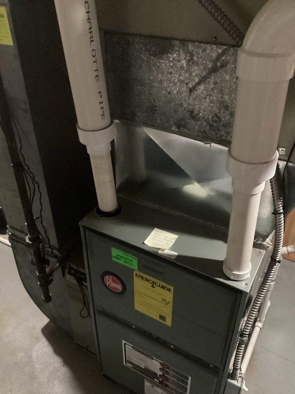 Replaced failed 1998 residential air conditioning system with new equipment. Installed replacement furnace unit in basement utility room with proper PVC venting, condensate drainage, and electrical connections to restore heating and cooling functionality to the home.