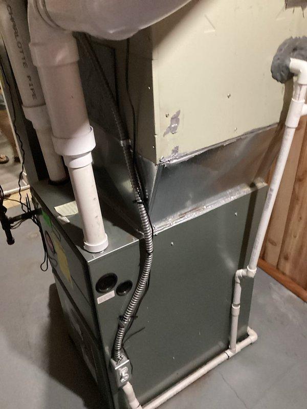 Replaced failed 1998 residential air conditioning system with new equipment. Installed replacement furnace unit in basement utility room with proper PVC venting, condensate drainage, and electrical connections to restore heating and cooling functionality to the home.