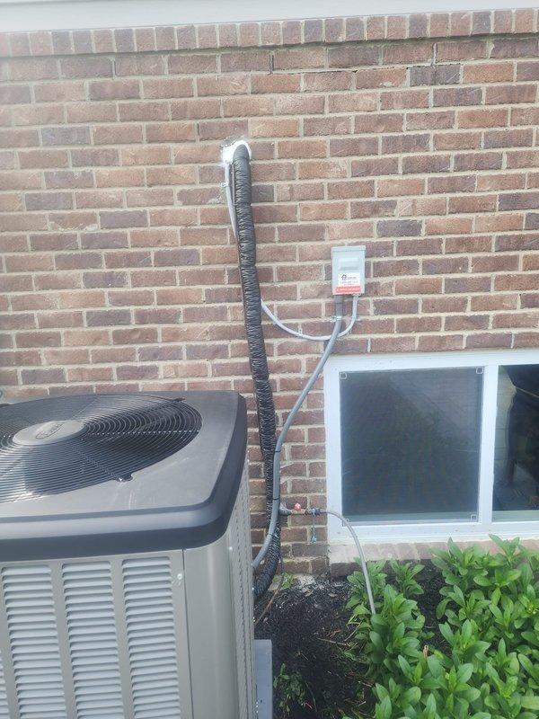 Completed full HVAC system installation including Lennox furnace, air conditioner, S40 thermostat, and humidifier. Installed outdoor condenser unit on concrete pad with proper electrical disconnect box mounted to exterior brick wall. Ran conduit and electrical connections from disconnect to unit per code requirements. Verified proper clearance for AC disconnect and all exterior components. Programmed and tested S40 thermostat to resolve reported programming concerns. Installed humidifier and integrated with new system. Removed old heating units from property as requested. Tested all equipment for proper operation including heating, cooling, and humidification functions. System running within manufacturer specifications. Documentation and photos completed for warranty follow-up.