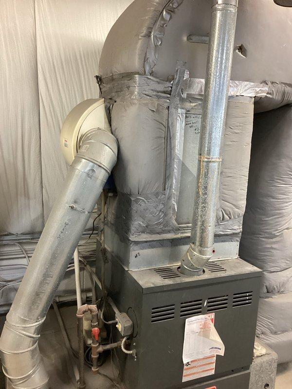 Completed commercial HVAC replacement estimate for upstairs furnace system. Documented existing basement furnace installation with metallic ductwork configuration and assessed three outdoor condenser units positioned on exterior concrete pads with associated electrical disconnects. Provided comprehensive replacement recommendations based on current system layout and equipment condition.