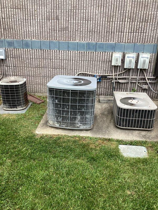 Completed commercial HVAC replacement estimate for upstairs furnace system. Documented existing basement furnace installation with metallic ductwork configuration and assessed three outdoor condenser units positioned on exterior concrete pads with associated electrical disconnects. Provided comprehensive replacement recommendations based on current system layout and equipment condition.