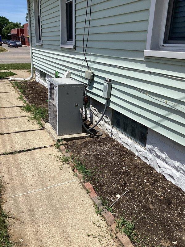 Completed comprehensive site assessment for full HVAC system replacement at residential property. Documented existing electrical service panel location and exterior utility connections to determine equipment placement and electrical requirements for new heating and cooling system installation.