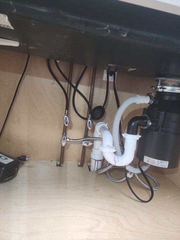 Completed install recall for kitchen faucet replacement. Verified proper installation of matte black pull-down spray faucet with undermount sink basin. Inspected under-sink plumbing connections, confirmed secure water supply line attachments with proper hose clamps, and verified garbage disposal integration with P-trap drainage system functioning correctly. All connections tested leak-free and installation completed to code.