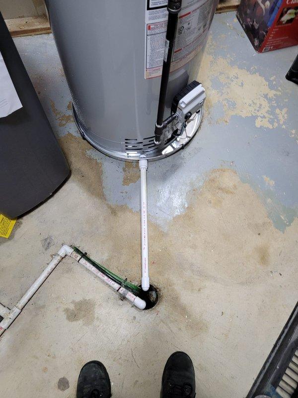 Completed installation of 50-gallon tanked water heater in basement utility area. Removed existing whole-house water filter system per sales agreement and proceeded with new water heater setup. Installed unit with proper seismic strapping at base for code compliance and safety. Connected water supply lines using appropriate piping configurations, including PVC discharge piping with T-junction setup at floor level. Verified all connections to existing copper supply lines and gas shutoff valve assembly. Ensured proper clearances around unit and confirmed all manufacturer specifications were met during installation. System tested and operational upon completion.
