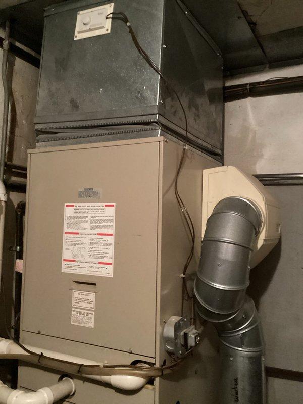 Conducted comprehensive site assessment for HVAC system replacement involving both outdoor and indoor equipment. Evaluated existing outdoor heat pump/air conditioning unit and electrical cabinet positioned on concrete pad, noting significant debris accumulation requiring clearance prior to installation. Assessed indoor furnace system located in basement mechanical room, including existing plenum, ductwork configuration, and condensate drainage system. Documented current equipment specifications and installation conditions through photographic records. Provided multiple replacement estimates covering air conditioning system upgrade and potential furnace replacement options to address aging equipment and improve system efficiency.