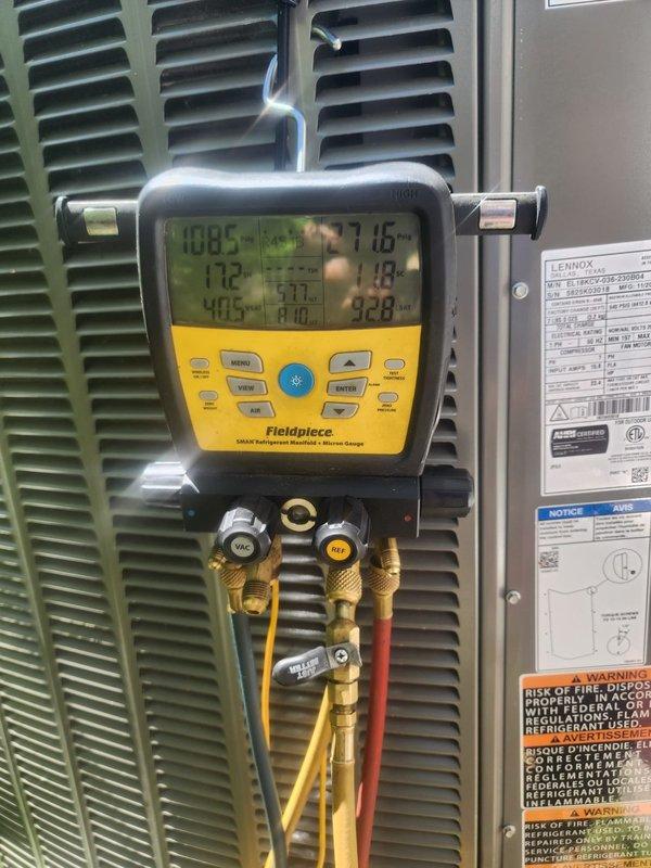 Responded to callback for AC unit not cooling properly with water pooling underneath. Upon arrival, performed diagnostic testing using digital manifold gauge to measure system pressures and temperatures. Readings indicated abnormal operating conditions with suction pressure at 108.5 PSI, discharge pressure at 405 PSI, and superheat at 7.16°F. Inspected condensate drain system and confirmed water accumulation was due to drainage issue. Cleared condensate line blockage and verified proper drainage flow. Rechecked refrigerant charge and system operation after repairs. Unit cooling properly with no further water pooling observed at time of departure.