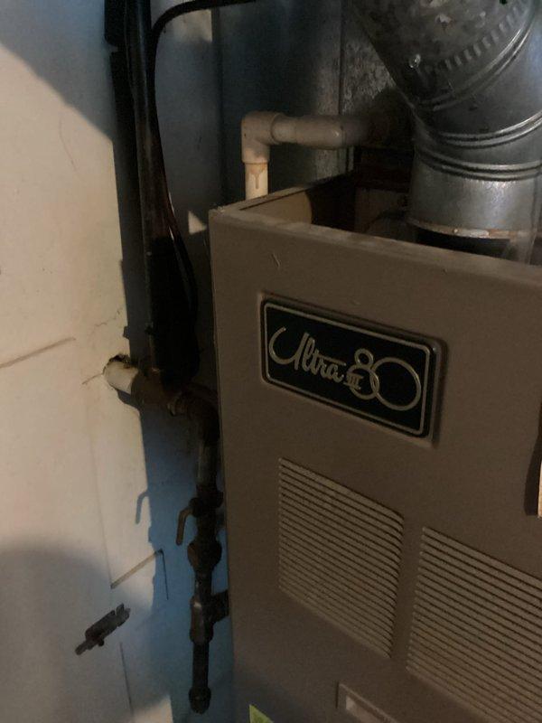 Conducted on-site evaluation of failed residential HVAC system in basement utility area. Assessed existing Ultra 80 furnace and associated air conditioning equipment that had reached end of service life and was no longer operational. Documented current system configuration including ductwork layout, electrical connections, condensate drainage, and venting infrastructure. Photographed equipment nameplate data, installation specifications, and surrounding mechanical room conditions to develop comprehensive replacement estimate for complete heating and cooling system.