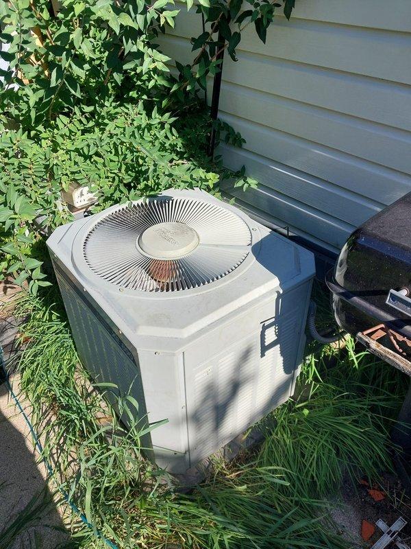# HVAC Service Completion Report

Responded to no cooling complaint on 30-year-old residential air conditioning system. Upon arrival, confirmed outdoor condenser unit had fan operation but no compressor function. Unit located at rear exterior of residence, surrounded by overgrown vegetation.

Performed diagnostic testing and determined compressor failure due to age-related component breakdown. Given the advanced age of the system (30 years, well beyond typical 15-20 year lifespan), recommended full system replacement rather than repair. Explained to customer that compressor replacement costs would approach new system pricing, and that additional failures were imminent given equipment age.

Performed electrical safety inspection of existing wiring connections. Identified loose wire connections at condensing unit requiring immediate attention. Secured all electrical connections using proper wire nuts and verified voltage at disconnect. Tested capacitor and contactor functionality - both 