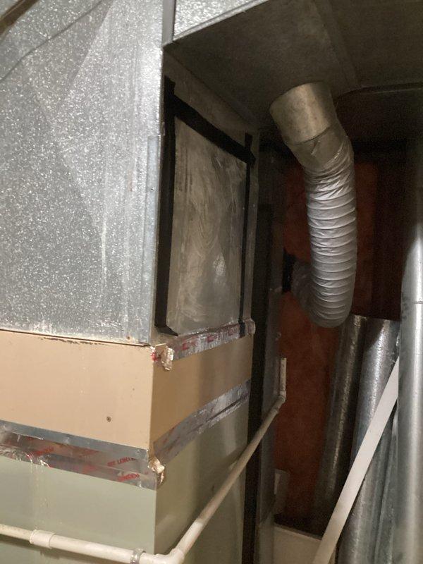Provided estimate for air conditioning system replacement at residential property. Current unit is operational but experiencing refrigerant leak and contains obsolete R-22 refrigerant, with equipment age exceeding 10 years. Assessed existing furnace and ductwork configuration in basement utility area to determine compatibility requirements for new system installation.