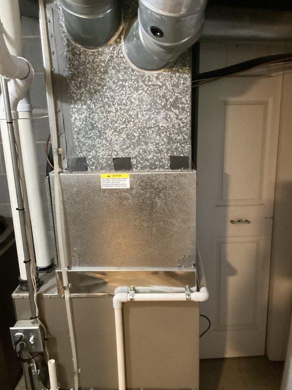 Completed on-site evaluation and provided replacement quote for 25-year-old residential air conditioning system that was not functioning. Assessed existing outdoor condensing unit located on rear side of property and indoor air handler unit installed in utility closet with associated ductwork and PVC condensate drainage. Documented current system configuration including electrical disconnect, refrigerant lines, and existing installation conditions through photographic records to support replacement equipment specifications and installation planning.