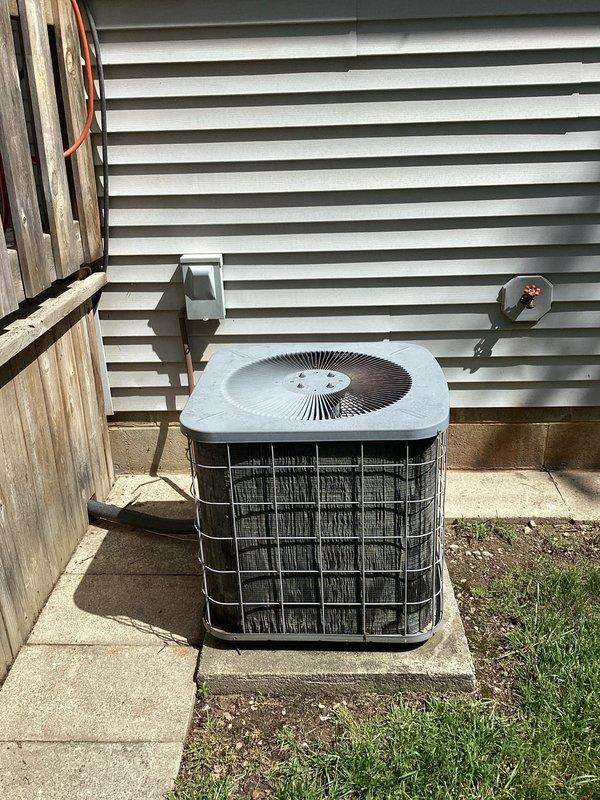 Completed on-site evaluation and provided replacement quote for 25-year-old residential air conditioning system that was not functioning. Assessed existing outdoor condensing unit located on rear side of property and indoor air handler unit installed in utility closet with associated ductwork and PVC condensate drainage. Documented current system configuration including electrical disconnect, refrigerant lines, and existing installation conditions through photographic records to support replacement equipment specifications and installation planning.