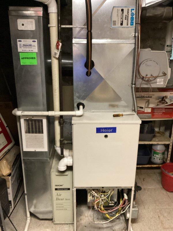 Conducted on-site evaluation of non-functional HVAC system utilizing obsolete R22 refrigerant with suspected blower motor failure. Assessed existing Haier air handler unit and aging furnace assembly in residential mechanical room, documenting current equipment configuration including electrical connections, refrigerant lines, ductwork connections, and auxiliary components such as humidifier integration. Provided comprehensive replacement estimate for complete heating and cooling system upgrade to address equipment failure and refrigerant phase-out requirements.