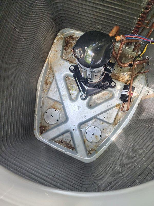 Completed annual cooling maintenance inspection on residential air conditioning system as part of Worry Free Service Agreement. Performed comprehensive system evaluation including condenser unit inspection, noting accumulated debris on coil fins requiring attention, and interior component assessment revealing rust formation on base pan and age-related corrosion on metal surfaces. Customer renewed maintenance agreement during service visit.