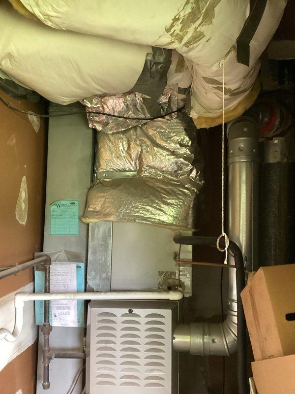 Conducted comprehensive site evaluation of existing HVAC system in basement utility area for equipment replacement estimate. Documented current furnace installation, air handler configuration, and ductwork layout including flexible insulated ducts and metal supply/return runs. Assessed mechanical space constraints, existing infrastructure connections, and preparation requirements for future system replacement.