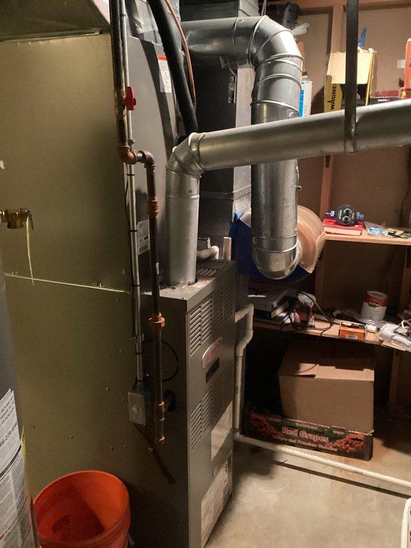 Completed comprehensive HVAC system evaluation for full equipment replacement estimate. Assessed existing furnace, air conditioning coil assembly, and associated ductwork in basement mechanical room, documenting current equipment condition including visible tarnishing on evaporator coil housing and overall system age. Provided detailed replacement recommendations and equipment specifications for complete system upgrade.