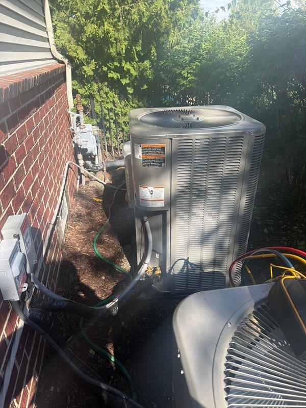 Completed installation of new Lennox air conditioning condenser unit at residential property. Unit was professionally positioned on exterior pad adjacent to existing HVAC equipment, with all refrigerant lines, electrical conduit, and connections properly installed and secured to manufacturer specifications. System was tested and confirmed operational upon completion.
