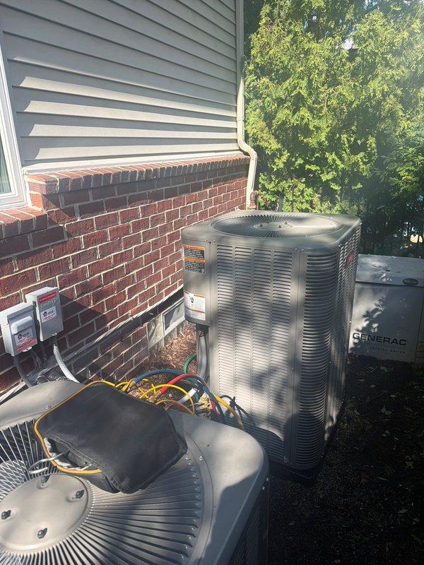 Completed installation of new Lennox air conditioning condenser unit at residential property. Unit was professionally positioned on exterior pad adjacent to existing HVAC equipment, with all refrigerant lines, electrical conduit, and connections properly installed and secured to manufacturer specifications. System was tested and confirmed operational upon completion.