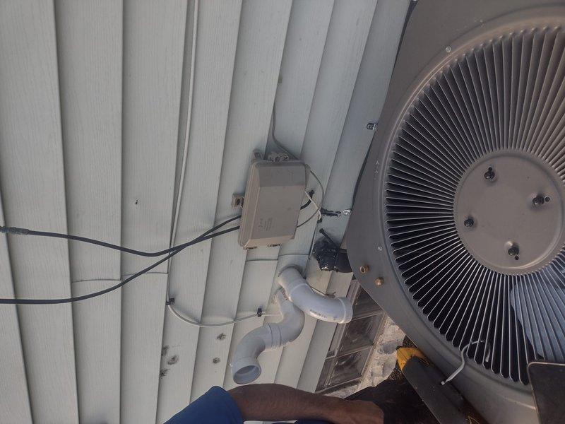 Completed full HVAC system installation including Lennox furnace with chimney liner, Lennox air conditioning condenser unit, and Ecobee6 smart thermostat. Installed exterior disconnect box with proper electrical connections, ran condensate drain lines with PVC piping, and mounted outdoor condenser unit against building exterior per manufacturer specifications. All equipment tested and operational, with proper airflow, electrical connections verified, and drainage system functioning correctly.