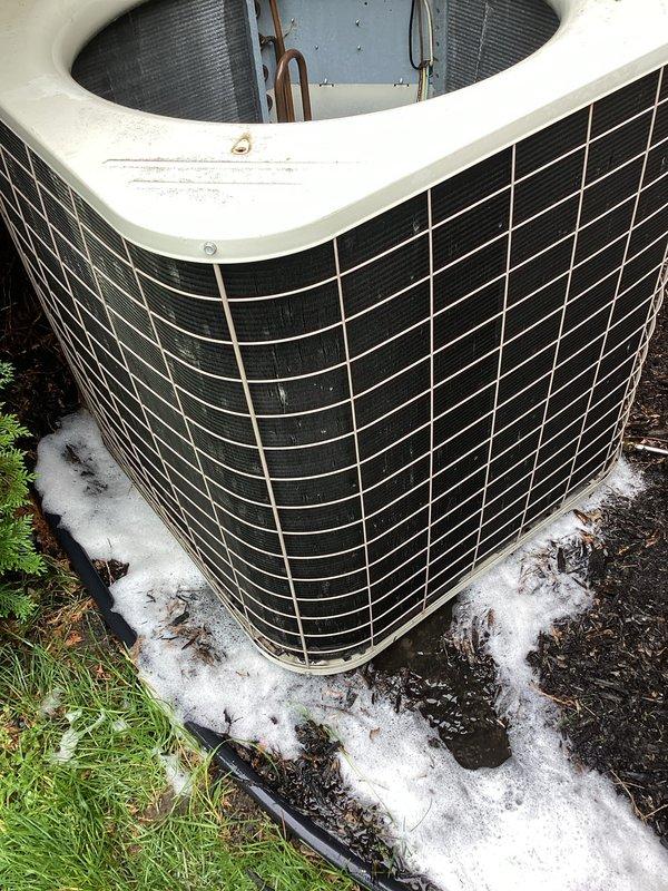 Responded to no cooling call on aging outdoor heat pump unit. Upon inspection, found unit with significant outdoor weathering, surface corrosion on copper refrigerant lines, and rust on compressor housing. Documented existing condition showing dirt accumulation in base pan, discolored exterior housing, and general operational wear consistent with 10+ years of service.