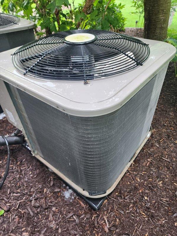 Completed preventative maintenance inspection on dual air conditioning system under Worry Free Service Agreement. Both outdoor condenser units were inspected, with all components found in good operating condition with no visible damage or deterioration noted. Units are properly positioned on rubber pads in landscaped areas with adequate clearance for airflow through louvered panels and top-mounted fan guards.