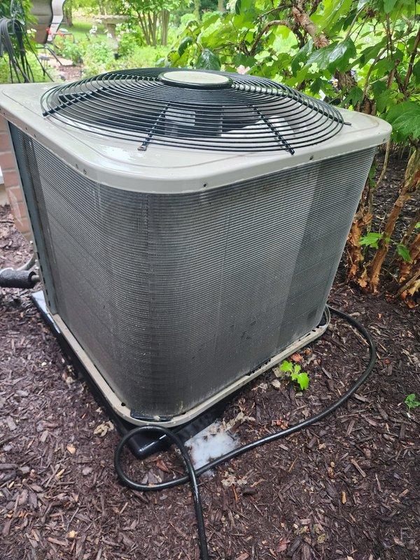 Completed preventative maintenance inspection on dual air conditioning system under Worry Free Service Agreement. Both outdoor condenser units were inspected, with all components found in good operating condition with no visible damage or deterioration noted. Units are properly positioned on rubber pads in landscaped areas with adequate clearance for airflow through louvered panels and top-mounted fan guards.