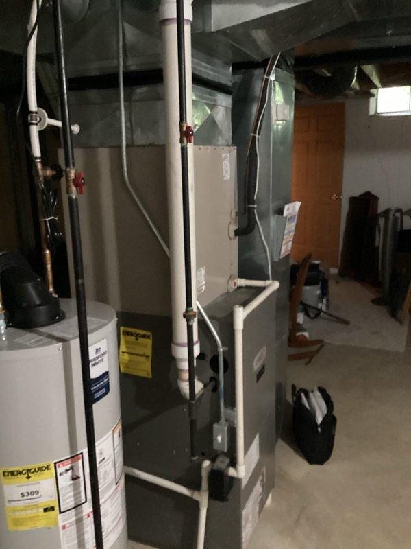 Provided comprehensive estimate for complete HVAC system replacement including both air conditioning unit and natural gas furnace, as existing equipment is non-operational and approaching 20 years of service life. Evaluated exterior AC unit mounted on brick wall with existing electrical disconnect and assessed basement-located furnace installation alongside water heater with current PVC venting configuration. Documented existing equipment conditions and mechanical room layout to prepare detailed replacement proposal for new heating and cooling system.