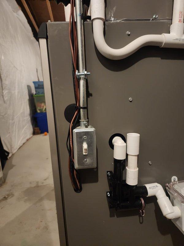 Completed full HVAC system installation in basement mechanical room including Lennox furnace, air conditioning unit, whole-home humidifier, S40 smart thermostat, and air scrubber system. Installed and configured all equipment with proper venting using white PVC condensate drain lines, copper refrigerant lines, gas line connections, and electrical components including junction box and wiring. All components mounted securely to concrete floor and walls with black flexible ductwork connections to existing distribution system, system tested and verified operational.