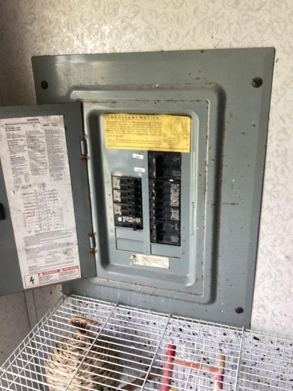 Conducted comprehensive HVAC system evaluation for equipment replacement estimate. Assessed existing dual air handler configuration, documented current unit conditions showing age-related wear and dust accumulation, and evaluated electrical service panel capacity with existing circuit breaker arrangement to determine compatibility requirements for new system installation.