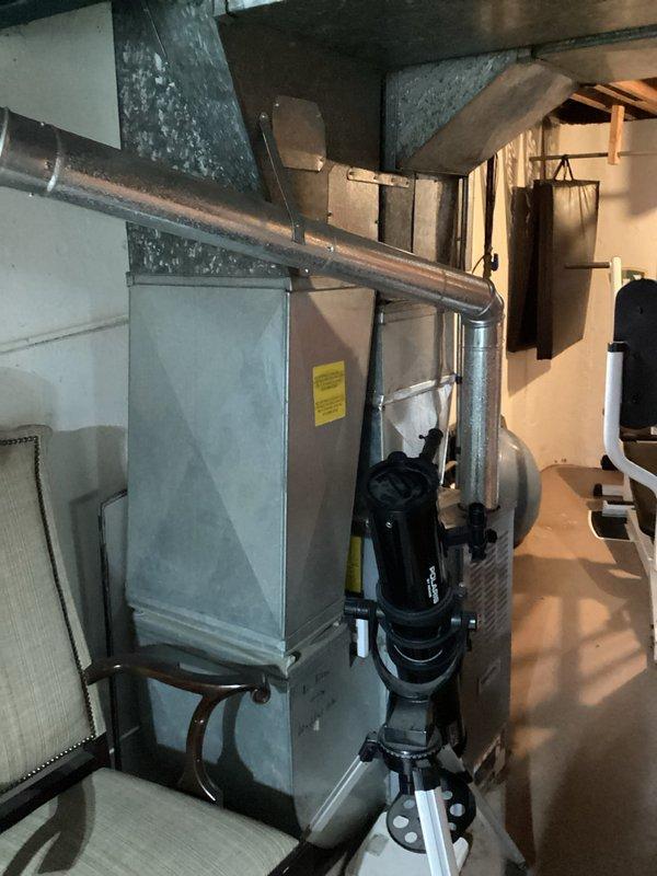 Completed air conditioning replacement estimate for customer at scheduled afternoon appointment. Assessed existing Tempstar furnace and HVAC system located in basement utility area, evaluated current ductwork configuration including horizontal and vertical metallic runs with elbow transitions, and documented equipment conditions through photographs to provide comprehensive replacement recommendations.